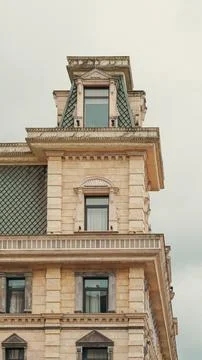 Classic building facade featuring a stone tower with a decorated mansard roof Stock Photos