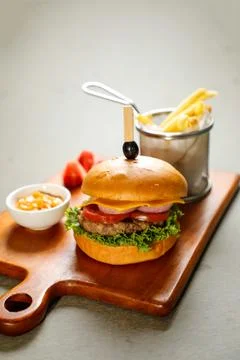 Classic Cajun Beef burger include cheese slice, tomato, onion and lettuce l.. Stock Photos