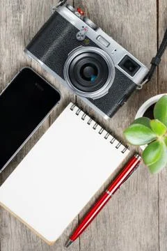 Classic camera with blank notepad page and red pen on gray wooden, vintage de Foto stock