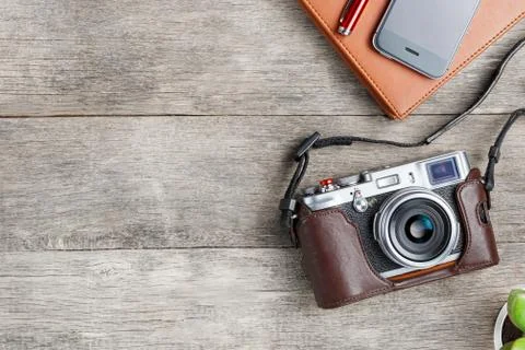 Classic camera with a brown organizer red pen on a gray wooden, vintage desk  Foto stock