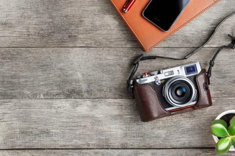 Classic camera with a brown organizer red pen on a gray wooden, vintage desk  Foto stock