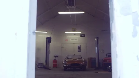 Classic Cars in a Workshop. Camera Moving Forward. Cars Ready to Restore Stock Footage 77925824