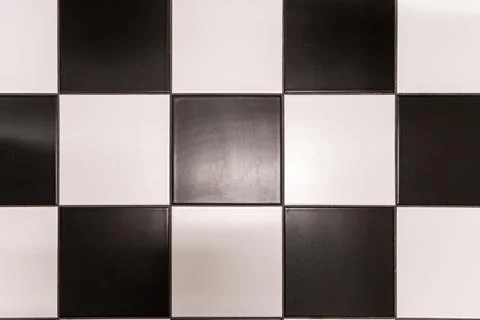 Classic checkerboard pattern with alternating black and white square tiles,.. Stock Photos