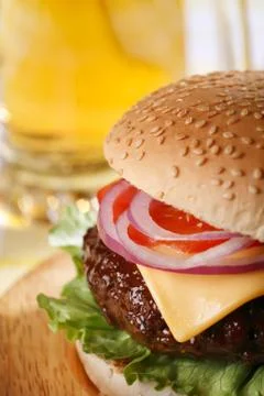 Classic cheeseburger with beer on background Stock Photos