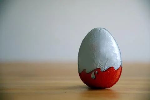 A classic chocolate egg resting on the table Stock Photos