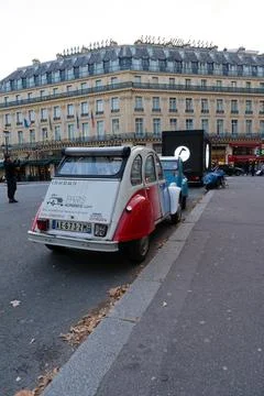 Classic Citroen car parked near iconic Parisian architecture on a crisp aut.. Stock Photos
