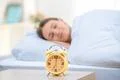 The classic clock on the background of a sleeping woman Photo