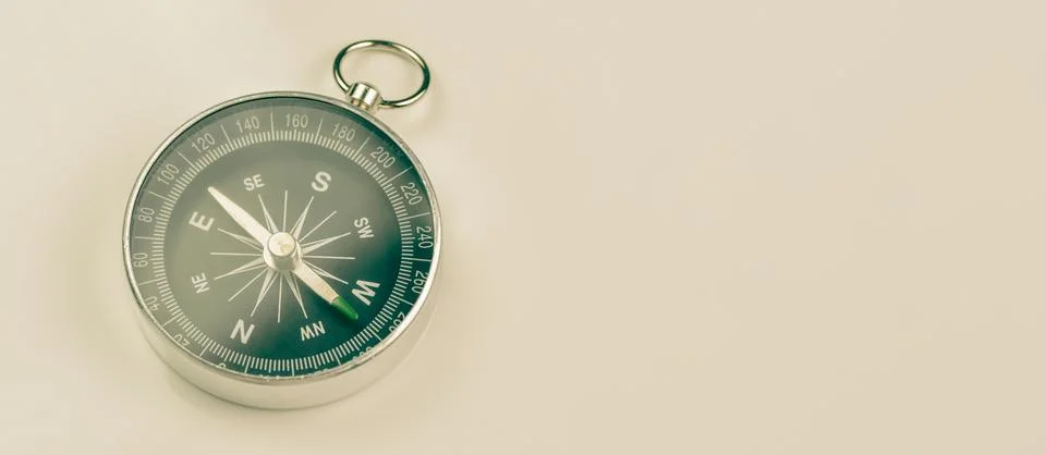 Classic compass on plain background with copy space Foto stock