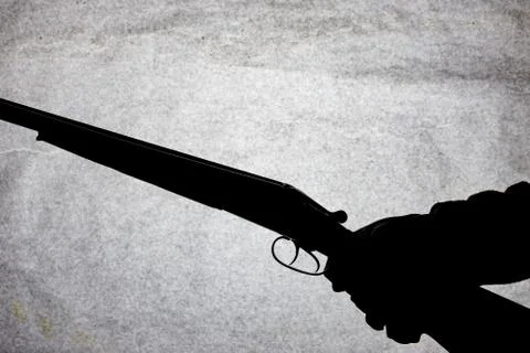 Classic double-barrell smooth-bore hunting rifle on man hand isolated on ligh Stock Photos