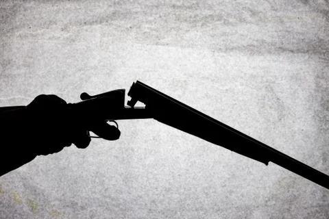 Classic double-barrell smooth-bore hunting rifle on man hand isolated on ligh Stock Photos