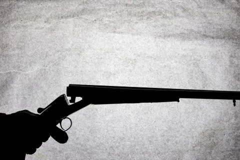 Classic double-barrell smooth-bore hunting rifle on man hand isolated on ligh Stock Photos