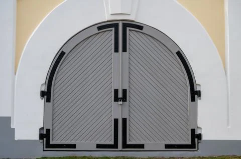 Classic double-leaf gate door in grey colour. Stock Photos