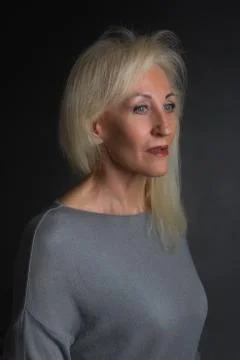 Classic dramatic portrait of elderly blonde woman in Studio Stock Photos