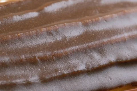 Classic eclair cake with chocolate icing custard filling, close up Stock Photos