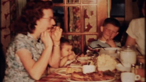 Classic family dinner around kitchen table 1950s vintage film home movie 4188 Stock Footage