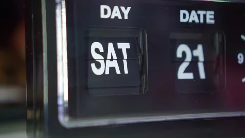 Classic flip clock transitioning date display, dim lighting, time passing and Stock Footage 343424872