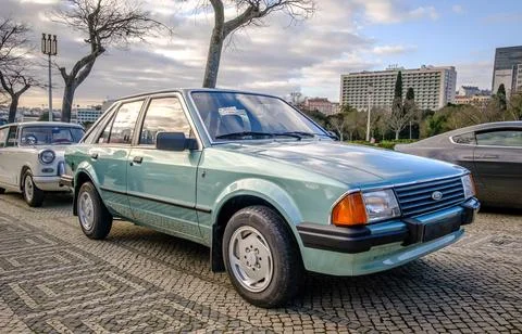 Classic Ford Escort 3rd generation car on cobblestone road Stock Photos