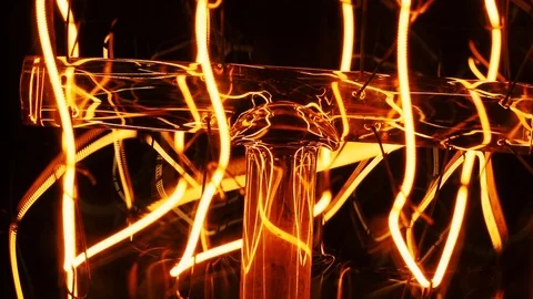 Classic glowing eddisson lamp close-up on black background. an old bulb Stock Footage 105460010