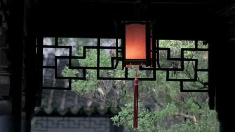 Classic glowing lantern hanging from carved wood in a Suzhou garden, China Stock Footage 337872105