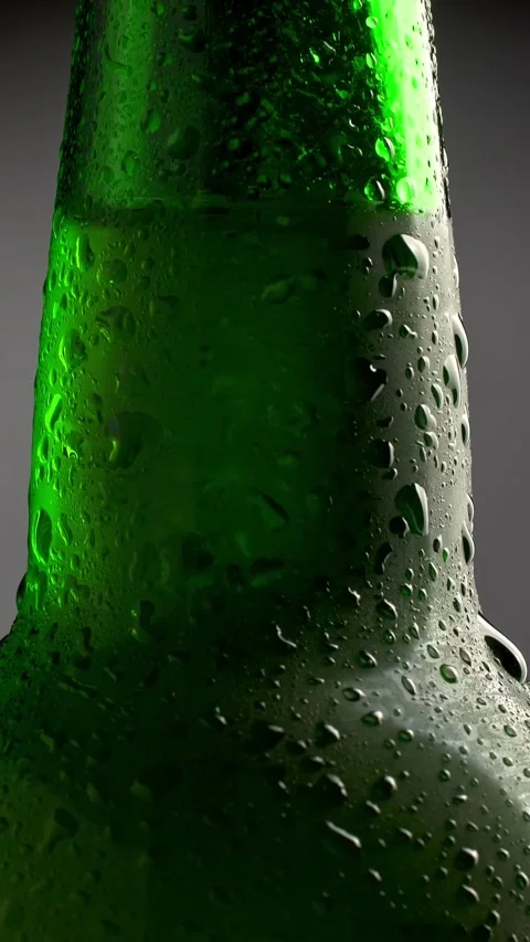 Classic green bottle of cold beer with condensate. Tilt shot with rotation Stock Footage 271262906