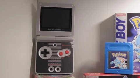 Classic handheld gaming console opened showing screen and controls Stock Footage 334656632
