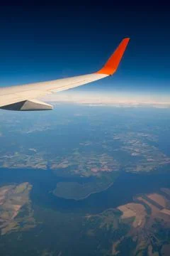 Classic image through aircraft window onto wing. Flight view over Russia Stock Photos