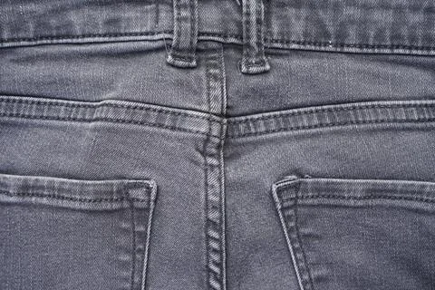 Classic jeans texture. Denim pattern back view, gray jeans background. Stock Photos