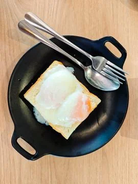 A classic Kopitiam breakfast featuring two soft, half-boiled eggs Stock Photos