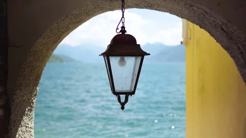 Classic lantern covered in spider webs with blurry view on lake Stock Footage 277255651