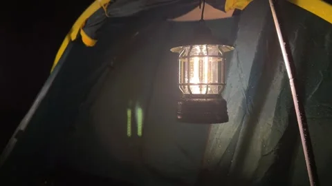 Classic Lantern Lowered Inside Green Camping Tent at Night, Medium Shot 스톡 동영상 323585427