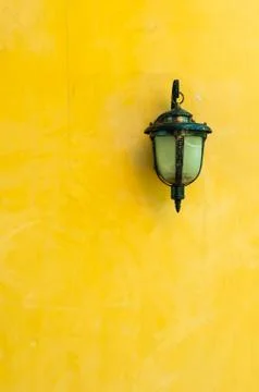 Classic lantern on yellow wall Stock Photos