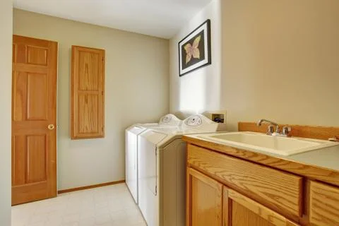 Classic laundry room with tile floor. Stock Photos