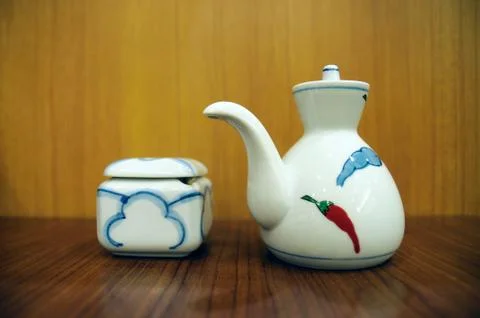 Classic little white kettle on table. Stock Photos