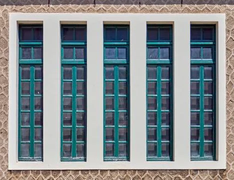 Classic modern linear window with blue green painted wooden frames Stock Photos