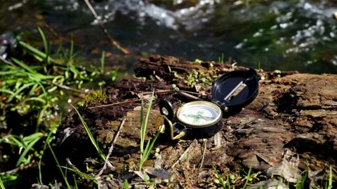 Classic navigation compass on natural background. compass putting on the gr.. Stock Footage 257871115