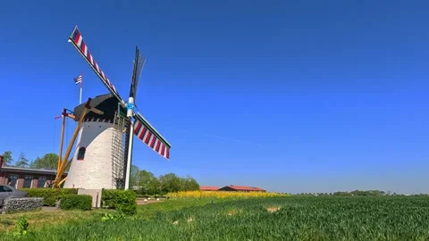 Classic Netherlands windmill surrounded by open landscape under a sunny blu.. Stock Footage 340228971