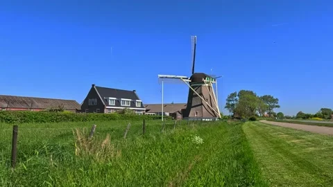 Classic Netherlands windmill surrounded by open landscape under a sunny blu.. Stock Footage 340229205
