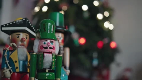 Classic Nutcracker Figures with Blurry Christmas Tree Lights Background Stock Footage 323031262
