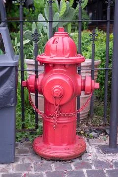 Classic old red fire hydrant on city street background. Pipe hose for fireman Stock Photos