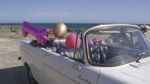 Classic open top Hillman Super Minx cabriolet on the beach decorated by balloons Stock-Footage 116729952