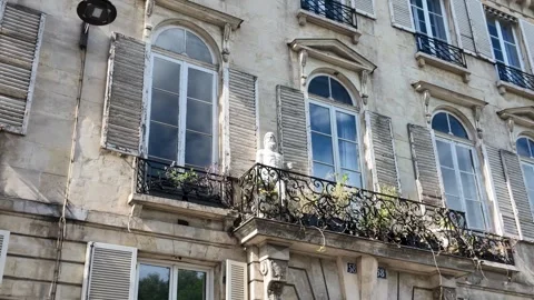 Classic Parisian Building Facade with Arched Windows and Wrought Iron Balconies Stock Footage 335734221