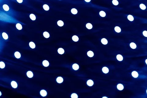 Classic polka dot textile background texture, white dots on blue luxury fabri Stockfoto's