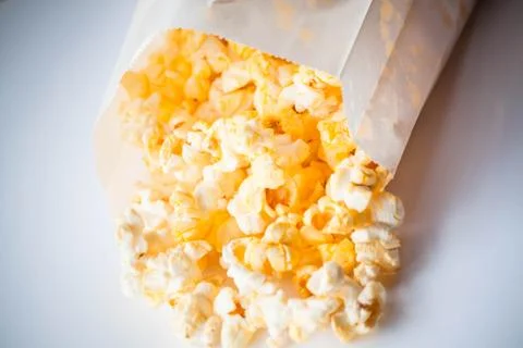 Classic popcorn falling out of paper pack Stock Photos