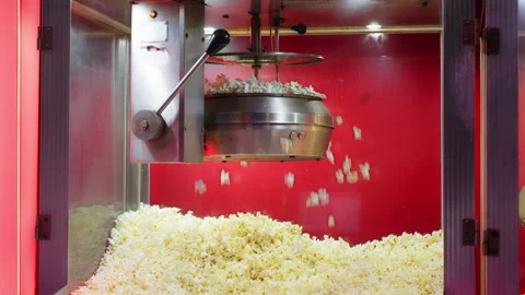 Classic popcorn machine producing fresh popcorn as fluffy kernels fall into.. Stock Footage 338189270