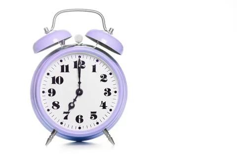 Classic purple table alarm clock on a white background Stock Photos