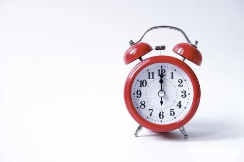 The classic red alarm clock is isolated on a white background Stock Photos