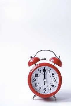 The classic red alarm clock is isolated on a white background Stock Photos