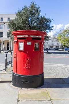 Classic red British post box on a city street corner. London, UK, 1 April 2024 Stock Photos