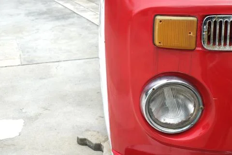 Classic red car front light parking in the field Stock Photos