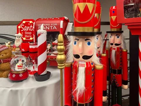 Classic red nutcracker figures standing among a festive display of traditio.. Stock Photos